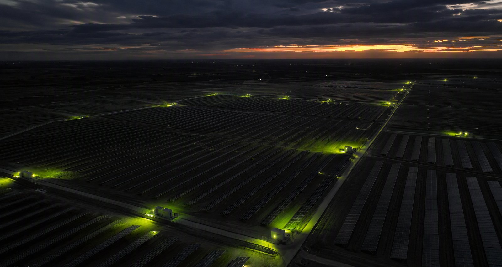 Aerial view of a utility-scale solar plant at dusk